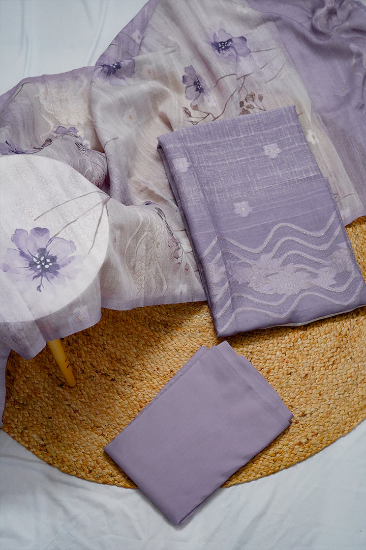 “Elegant lavender unstitched cotton salwar suit for women with floral printed dupatta, featuring premium salwar suit dress material perfect for custom stitching. Shop unstitched salwars online or buy unstitched salwar suits online in Kerala and Kottayam