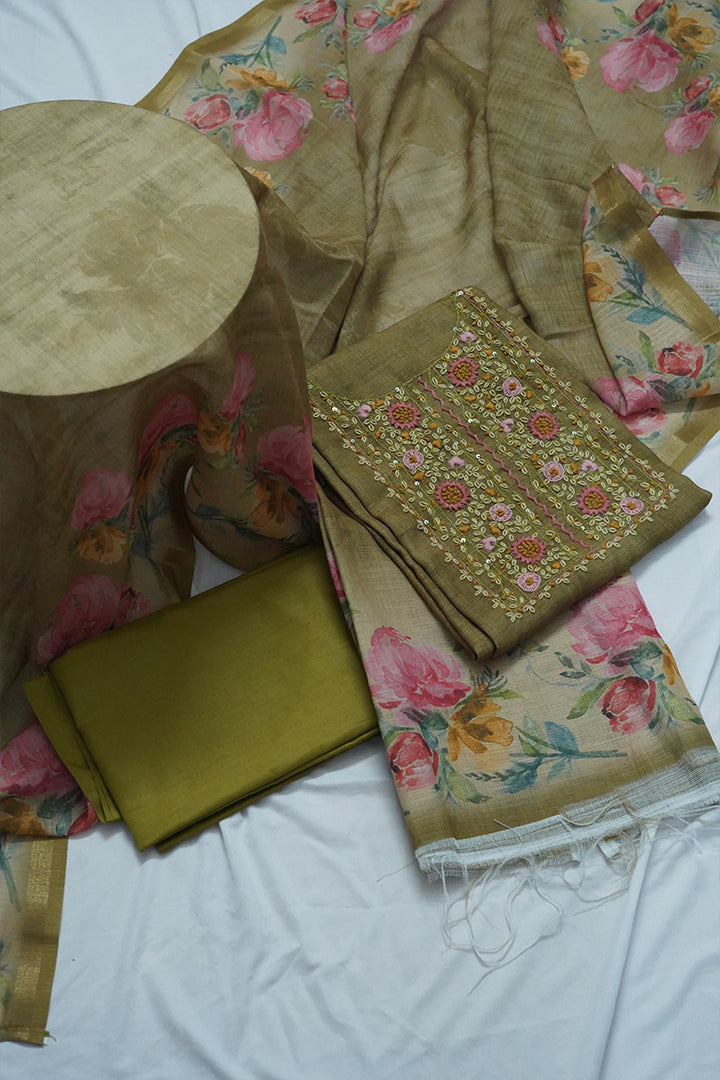 “Olive green unstitched cotton salwar suit for women with floral printed dupatta and intricate embroidered neckline, perfect unstitched salwar suit dress material for festive and casual wear. Buy unstitched salwar suits online in Kerala and Kottayam.”
