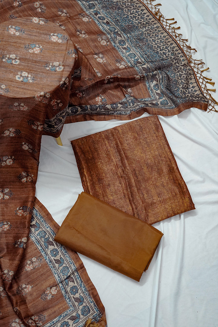 Elegant brown unstitched cotton salwar suit for women with a printed dupatta featuring traditional floral and border designs. Premium unstitched salwar suit dress material ideal for custom tailoring. Shop unstitched cotton salwar suits with dupatta and buy unstitched salwar suits online for a personalized ethnic look.